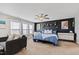 This main bedroom features a black accent wall, lots of natural light, and neutral carpet at 1213 Valley Dale Dr, Fuquay Varina, NC 27526
