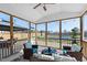 Screened porch with wicker furniture overlooking pool, backyard and landscaping at 1213 Valley Dale Dr, Fuquay Varina, NC 27526