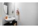Cozy powder room featuring modern sink and mirror at 1213 Valley Dale Dr, Fuquay Varina, NC 27526