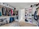 A well-organized walk-in closet with custom shelving and a center ottoman at 1213 Valley Dale Dr, Fuquay Varina, NC 27526