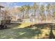 Backyard shot with tennis court and storage building in the distance at 1221 Renshaw Ct, Cary, NC 27518