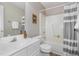 Bathroom featuring a vanity with sink, toilet, and a shower-tub combination with a patterned curtain at 1221 Renshaw Ct, Cary, NC 27518