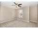 Empty bedroom with neutral carpeting and ceiling fan offers versatility in its use at 1221 Renshaw Ct, Cary, NC 27518