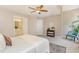 Neutral bedroom featuring a queen bed, ceiling fan, and en suite bathroom with a double sink vanity at 1221 Renshaw Ct, Cary, NC 27518