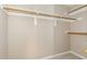 Walk-in closet features neutral carpeting and multiple shelves for organization at 1221 Renshaw Ct, Cary, NC 27518