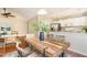 Bright dining area with a wooden table, decorative centerpiece, and seamless flow into the kitchen and living room at 1221 Renshaw Ct, Cary, NC 27518