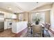 Eat-in kitchen with stainless appliances, white cabinets, and a dining table at 1221 Renshaw Ct, Cary, NC 27518