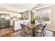 Eat-in kitchen with stainless appliances, white cabinets, and a dining table at 1221 Renshaw Ct, Cary, NC 27518