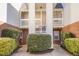 Exterior view of building with brick accents and landscaped bushes in front at 1221 Renshaw Ct, Cary, NC 27518