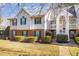 Charming multi-story townhouse with manicured landscaping, brick accents, and private balconies at 1221 Renshaw Ct, Cary, NC 27518