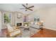 Cozy living room featuring a fireplace, ceiling fan and a comfortable seating arrangement at 1221 Renshaw Ct, Cary, NC 27518
