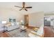 Open-concept living room featuring a ceiling fan and a comfortable seating arrangement at 1221 Renshaw Ct, Cary, NC 27518
