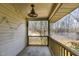 Covered patio with a fan offering views of the surrounding greenery and tennis court at 1221 Renshaw Ct, Cary, NC 27518