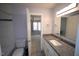 Bathroom featuring a toilet, vanity with granite countertop and an open doorway to the bedroom at 1501 Ramson Ct, Raleigh, NC 27603