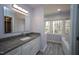 Well-lit bathroom with granite vanity, linen closet, and large soaking tub at 1501 Ramson Ct, Raleigh, NC 27603