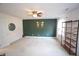Spacious bedroom featuring a neutral carpet, a ceiling fan, and green accent wall at 1501 Ramson Ct, Raleigh, NC 27603