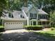 Inviting two-story home features a two-car garage, lush landscaping, and a welcoming front porch at 1501 Ramson Ct, Raleigh, NC 27603