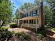 Well-maintained two-story home with charming front porch, complemented by established landscaping and mature trees at 1501 Ramson Ct, Raleigh, NC 27603