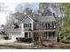 Traditional two-story home featuring an attached garage, front porch, and mature trees in a landscaped yard at 1501 Ramson Ct, Raleigh, NC 27603
