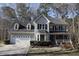 Charming two-story home featuring a covered front porch, attached garage, and well-maintained landscaping at 1501 Ramson Ct, Raleigh, NC 27603