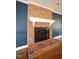 Close-up of a classic brick fireplace with a white mantel and hearth in the living room at 1501 Ramson Ct, Raleigh, NC 27603