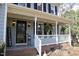 Inviting front porch with white railings, decorative plants, and a welcome sign at 1501 Ramson Ct, Raleigh, NC 27603