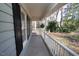 Covered front porch with white railings and black shutters, offering a cozy outdoor space at 1501 Ramson Ct, Raleigh, NC 27603