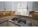 Close-up of stainless sink with modern faucet, granite countertops, and tiled backsplash at 1501 Ramson Ct, Raleigh, NC 27603