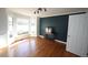 Cozy living room with hardwood floors, accent wall, and bay window at 1501 Ramson Ct, Raleigh, NC 27603