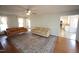 Open-concept living room featuring hardwood floors, a neutral rug, and a view into the kitchen at 1501 Ramson Ct, Raleigh, NC 27603