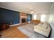 Bright living room with hardwood floors, a brick fireplace, and comfortable seating arrangement at 1501 Ramson Ct, Raleigh, NC 27603