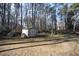A backyard shed surrounded by trees. Great for storing yard equipment and tools at 1501 Ramson Ct, Raleigh, NC 27603