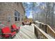 Back deck with wooded view, outdoor dining area and built-in grill at 156 Stoney Creek Way, Chapel Hill, NC 27517