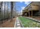 A sprawling backyard features artificial turf, a patio with a firepit, and access to a screened-in porch at 156 Stoney Creek Way, Chapel Hill, NC 27517