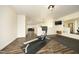 Finished basement featuring dark wood-look floors and home gym with mounted TV at 156 Stoney Creek Way, Chapel Hill, NC 27517