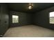 Empty bedroom featuring neutral carpet, natural light, and dark trim at 156 Stoney Creek Way, Chapel Hill, NC 27517