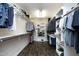 Walk-in closet featuring custom storage systems with shelves and hanging rods at 156 Stoney Creek Way, Chapel Hill, NC 27517