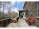 Expansive wooden deck features outdoor seating and a serene view of the wooded backyard at 156 Stoney Creek Way, Chapel Hill, NC 27517