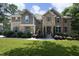 Beautiful two-story home featuring a well-manicured lawn and a stone and brick facade at 156 Stoney Creek Way, Chapel Hill, NC 27517