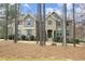 Inviting two-story home with stone and siding, surrounded by mature trees and landscaped yard at 156 Stoney Creek Way, Chapel Hill, NC 27517