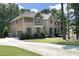 Spacious home with brick and stone details, a long driveway, and lush green landscaping at 156 Stoney Creek Way, Chapel Hill, NC 27517
