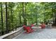 Charming outdoor fire pit with stone surround and adirondack chairs, perfect for relaxation and entertainment at 156 Stoney Creek Way, Chapel Hill, NC 27517