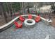 Stone fire pit area with Adirondack chairs provides an inviting outdoor gathering space at 156 Stoney Creek Way, Chapel Hill, NC 27517
