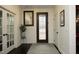 Elegant foyer with dark hardwood floors, decorative front door, and view of a glass paneled french door at 156 Stoney Creek Way, Chapel Hill, NC 27517
