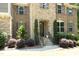 Inviting front entrance with stone steps, elegant landscaping, and a detailed front door at 156 Stoney Creek Way, Chapel Hill, NC 27517