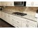 Close-up of a kitchen with granite countertops, stainless steel appliances, and white cabinetry at 156 Stoney Creek Way, Chapel Hill, NC 27517