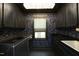 Laundry room with dark cabinetry, floral wallpaper, and modern lighting at 156 Stoney Creek Way, Chapel Hill, NC 27517