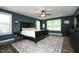 Spacious main bedroom featuring stylish wall décor, soft carpet, and natural light from surrounding windows at 156 Stoney Creek Way, Chapel Hill, NC 27517