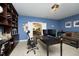 Home office featuring built-in bookshelves, work desk, and comfortable seating area at 156 Stoney Creek Way, Chapel Hill, NC 27517
