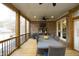 Screened porch with dining table, ceiling fans and view of back yard at 156 Stoney Creek Way, Chapel Hill, NC 27517
